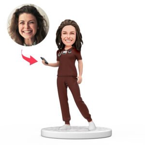 Female Doctor Bobblehead in Red Scrubs Holding a Phone