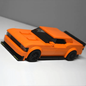 Orange muscle car building blocks model with sleek design, black wheels and aerodynamic front splitter on a clean background
