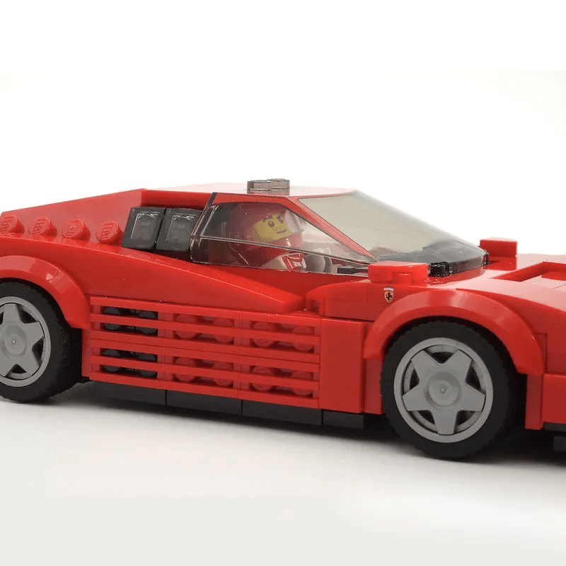 Classic red sports car building blocks model with sleek design, detailed front grille and headlights, displayed on a clean background