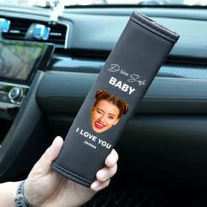 Custom car seat belt cover with a woman’s face and text, held inside a car interior