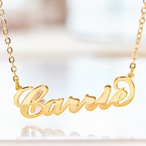 Gold personalized name necklace with “Carrie” in cursive script pendant on a delicate chain.