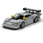 Gray brick-built sports car model with detailed body, yellow side mirrors, and a large rear spoiler on a white background.