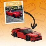 Comparison of real red sports car photo and matching brick-built model with arrow showing transformation on orange background