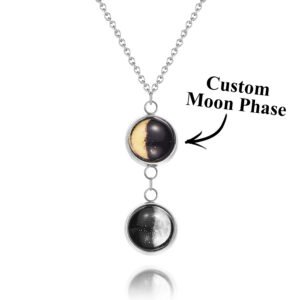 Custom Moon Phase Necklace showing three connected pendants with engraved phases of the moon, personalized with a photo of a smiling elderly couple in the background, silver chain