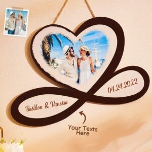 CBS8553jpg - Printshop4me.au Personalized heart-shaped wooden plaque hanging on a wall featuring a printed photo of a smiling couple in summer attire. Text areas on the plaque display 'Basilon & Vanessa' and the date '04.24.2022', with an arrow pointing to the area labeled 'Your Texts Here' for customization."
