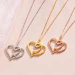 Three heart-shaped personalized name necklaces in silver, gold, and rose gold, each with cursive text 'Ramas Sephia', displayed on a light pink background.