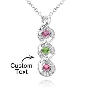 A silver vertical pendant necklace featuring a twisted design with three round birthstone gems and engraved names along the twist, displaying customizable text for personalization.