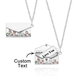 A silver envelope-shaped pendant necklace with colorful floral cutout designs, showing a hidden compartment inside that can hold a customizable message card with text such as "Love You," hanging from a delicate silver chain.