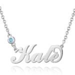 Personalized silver necklace featuring the name 'Kate' in elegant cursive script, accented with a small round blue gemstone on the chain, isolated on a white background.