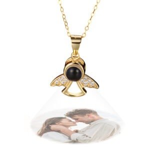 Custom projection necklace in gold shaped like an angel with sparkling wings, projecting a photo of a couple embracing outdoors.
