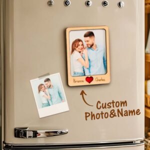 A refrigerator door displaying a custom wooden photo magnet featuring a couple’s picture, labeled “Brianna ❤ Charles.” Below it, a handwritten-style arrow and text reading “Custom Photo & Name” points toward the personalized magnet, with a smaller printed photo attached beside it, showcasing a customizable gift display.
