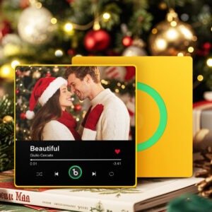 Personalized Christmas-themed custom photo music plaque featuring a couple wearing Santa hats, smiling and leaning close in front of a festive holiday background. The design displays the song “Beautiful” by Giulio Cercato in a Spotify-style player interface with playback controls and a heart icon. The plaque has a yellow frame with a green circular record element on the right, set against a blurred Christmas tree background with ornaments and warm lights.